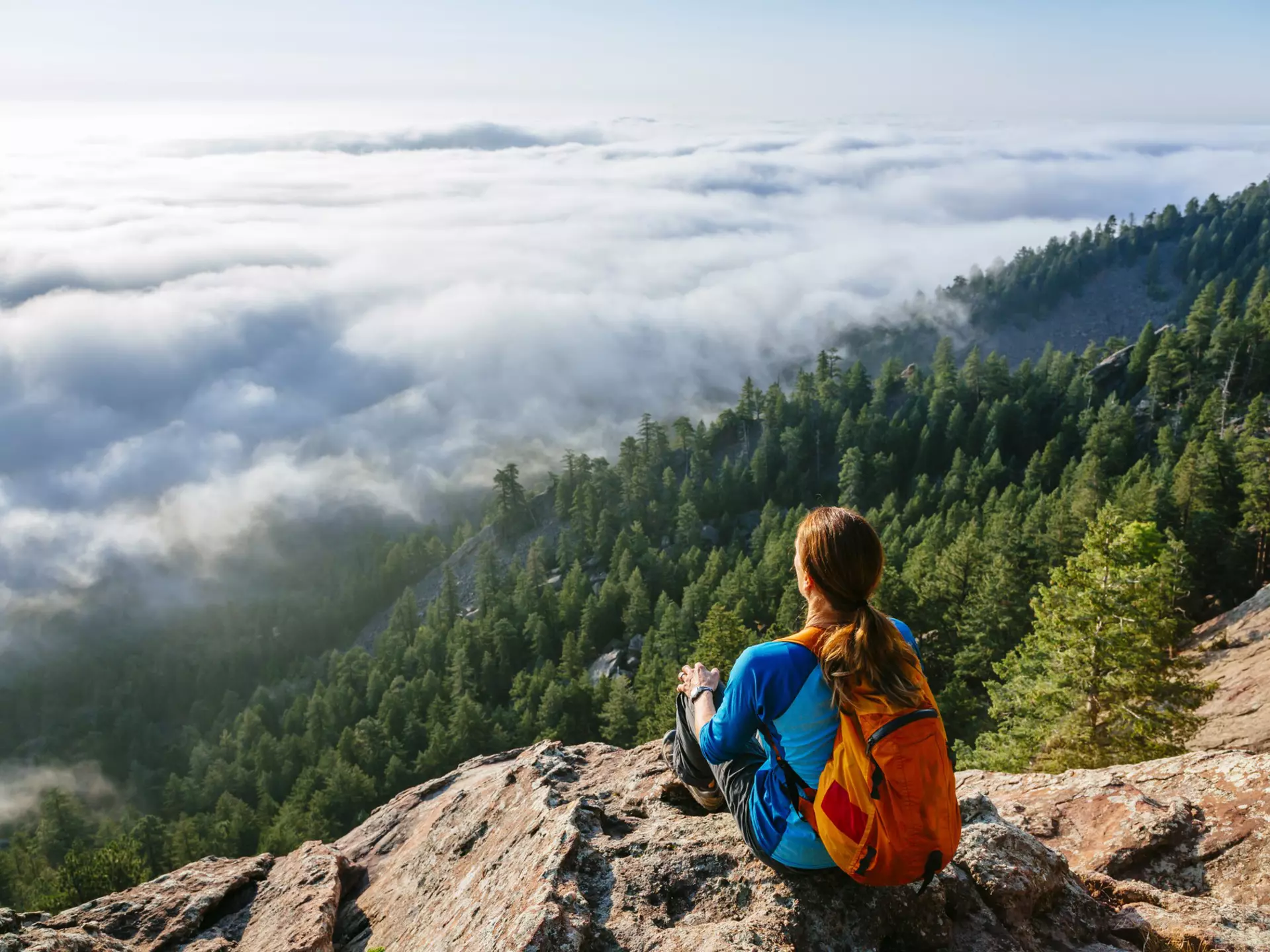 A female hiker rests at a mountain viewpoint above Boulder, CO
673024167