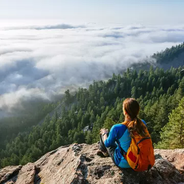 A female hiker rests at a mountain viewpoint above Boulder, CO
673024167