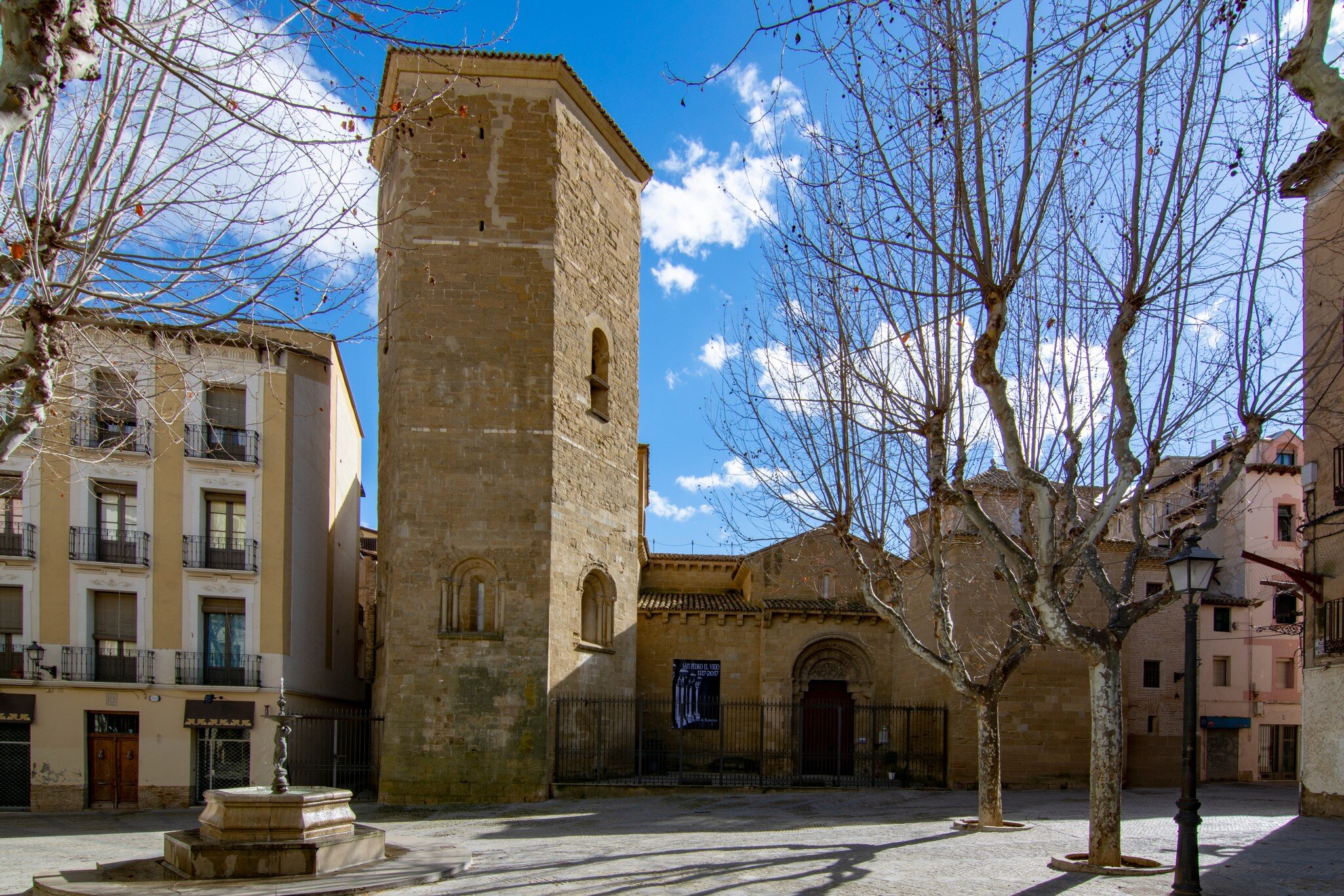 Huesca, Spain; March 2017: view of the bell tower and entrance of the church San Pedro in center historic of Huesca; Shutterstock ID 1358576033;