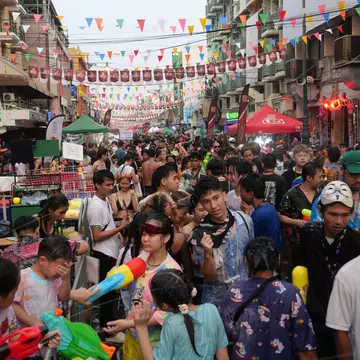 Bangkok, Thailand-April 13, 2023: Locals and tourists celebrate Songkran Festival, Traditional Thai New Year. People play water, and use water guns to enjoy the festival at Thanon Khao San, License Type: media, Download Time: 2026-06-10T14:54:14.000Z, User: LP_NZhan, Editorial: true, purchase_order: 65050 - Digital Destinations and Articles, job: App Content, client: Lonely Planet App, other: Nadine Zhan