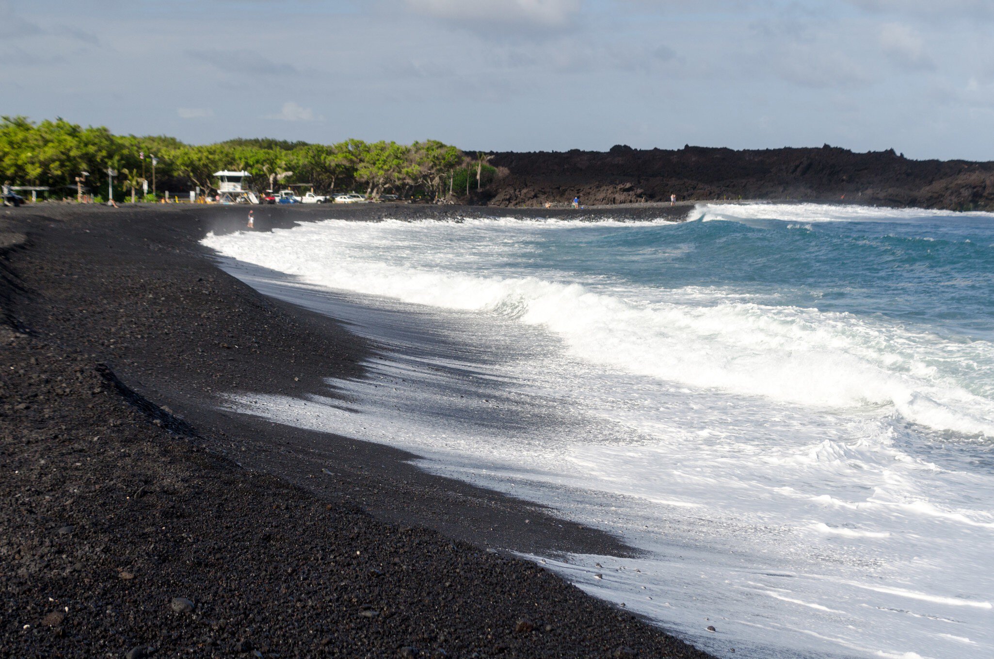Rough surf  at edge of black sands of Pohoiki  beach, Isaac Hale Beach Park, Big Island, hawaii