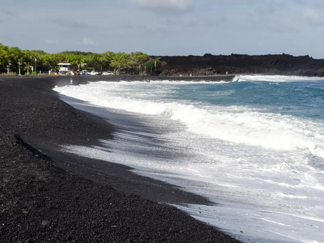Rough surf  at edge of black sands of Pohoiki  beach, Isaac Hale Beach Park, Big Island, hawaii