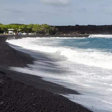 Rough surf  at edge of black sands of Pohoiki  beach, Isaac Hale Beach Park, Big Island, hawaii