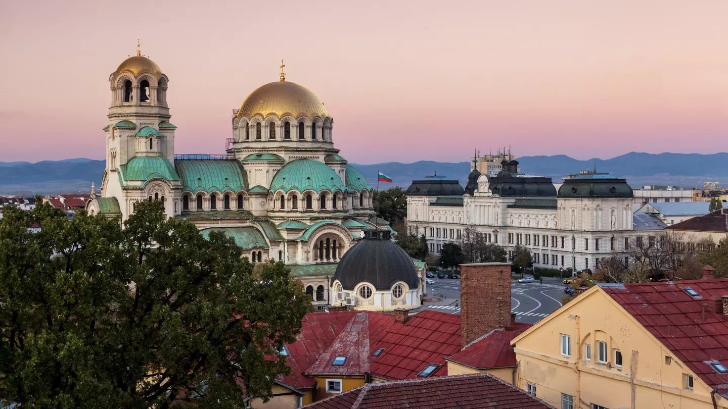 A gold-domed church building at sunset.