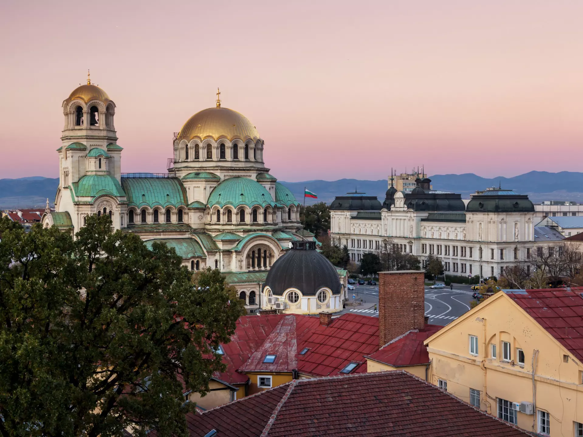 A gold-domed church building at sunset.