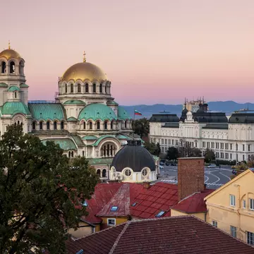 A gold-domed church building at sunset.