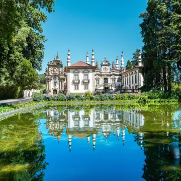 View of the Casa de Mateus in the Douro Valley, Portugal, with a pond in the foreground.