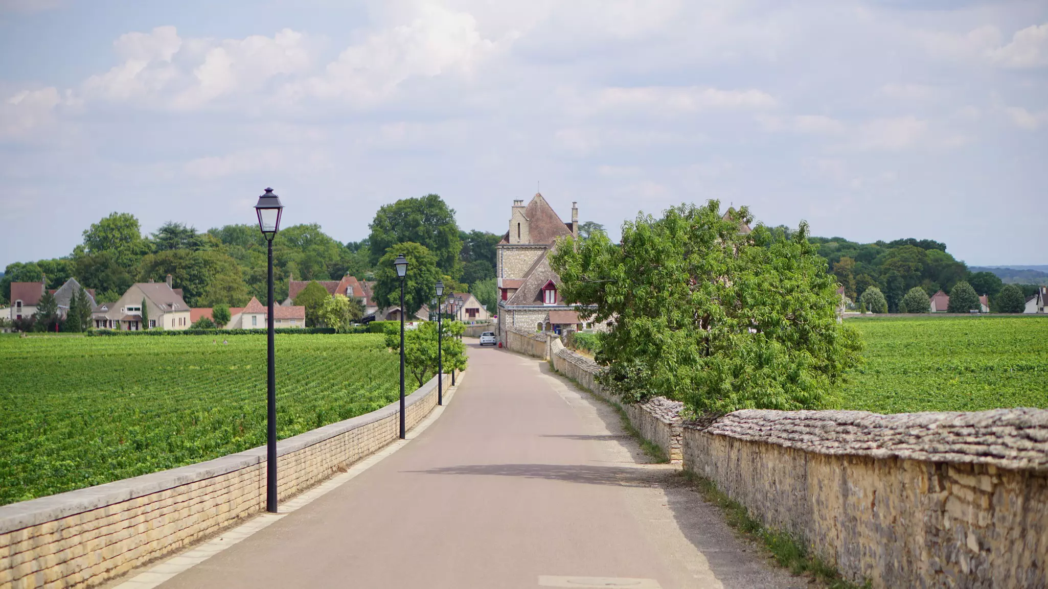 A view of the Burgundy countryside through the windscreen of a couple on a road trip