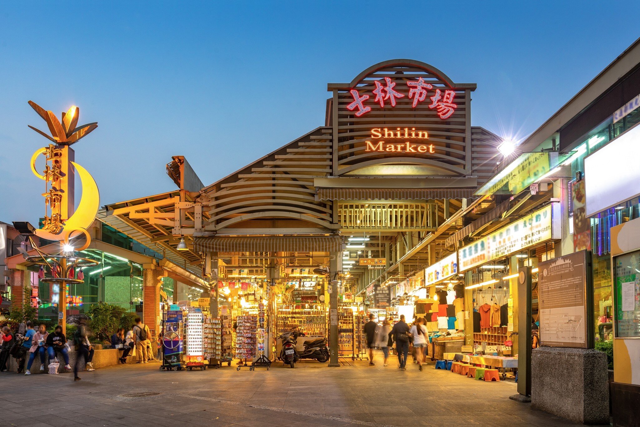 The neon signs of the Shilin night market covered building in Taipei, Taiwan.