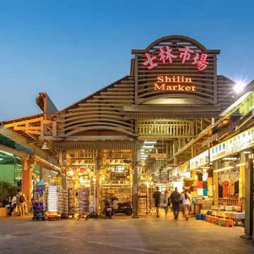 The neon signs of the Shilin night market covered building in Taipei, Taiwan.