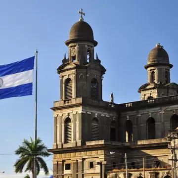 Old cathedral with the Nicaraguan flag flying outside