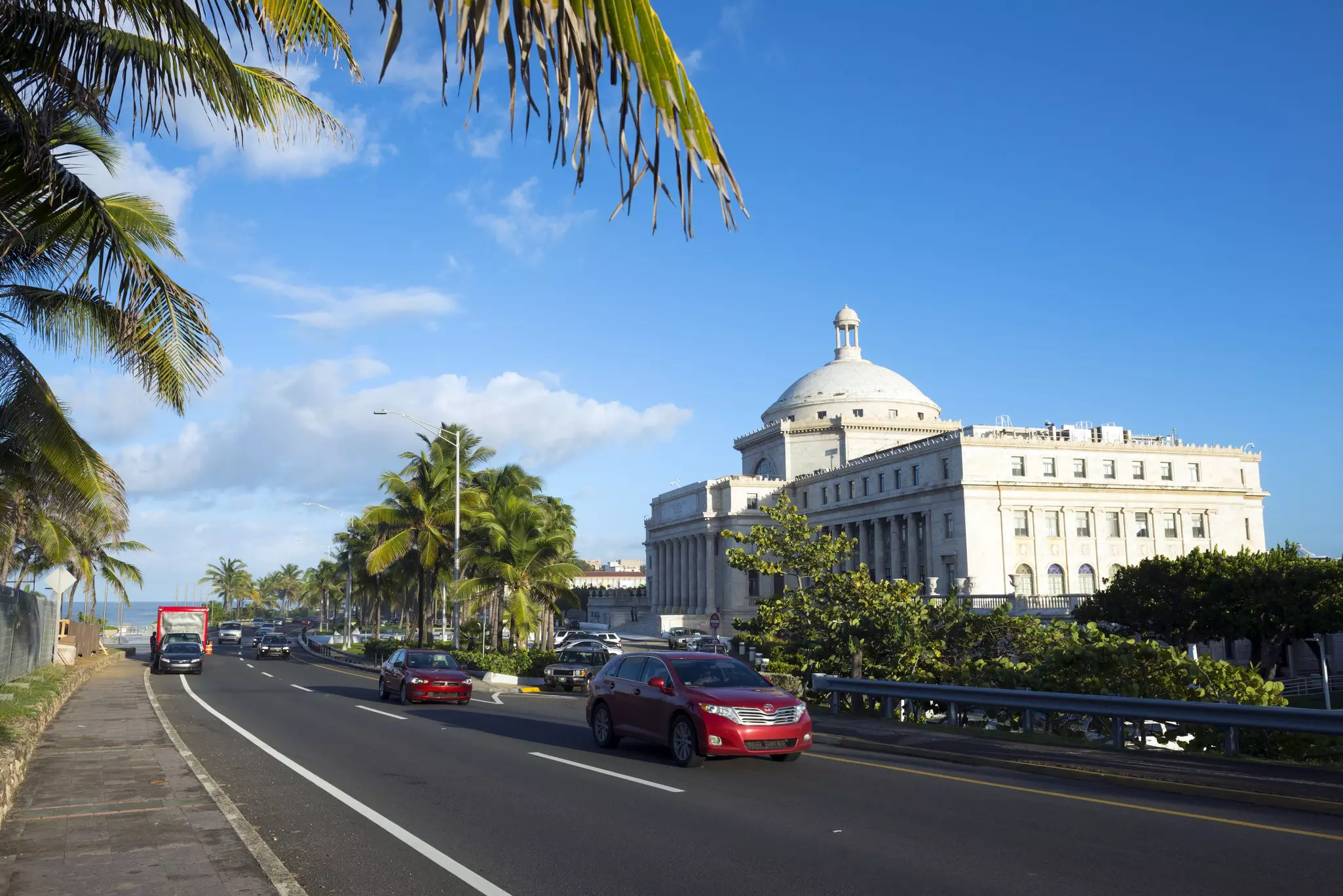 Cars travel past the Capitol Building (El Capitolio) in San Juan, Puerto Rico.