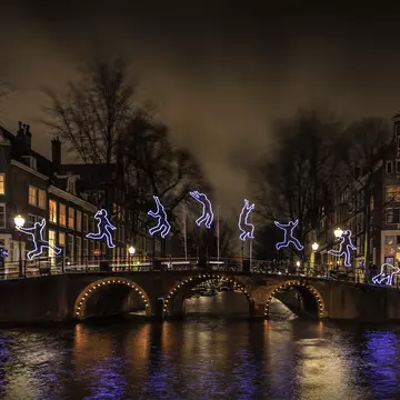A canal bridge lit up for the Amsterdam Light Festival