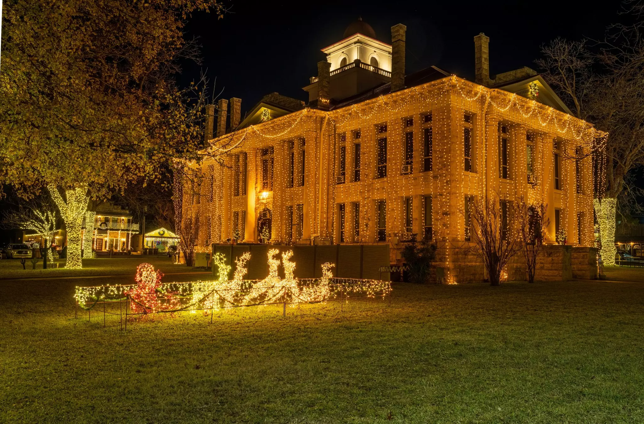 Twinkling lights hanging from the Blanco County courthouse each December in Johnson City, Texas