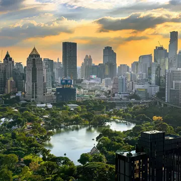  Scenic view of downtown Bangkok with Lumpini park surrounded by high rises at sunset, Thailand, Southeast Asia