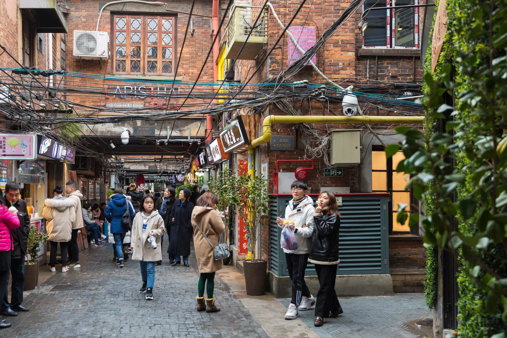 Young people exploring the lanes of Tianzifang in the former French Concession, Shanghai, China.