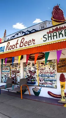 Signs advertising fast food are displayed on the exterior of a diner.