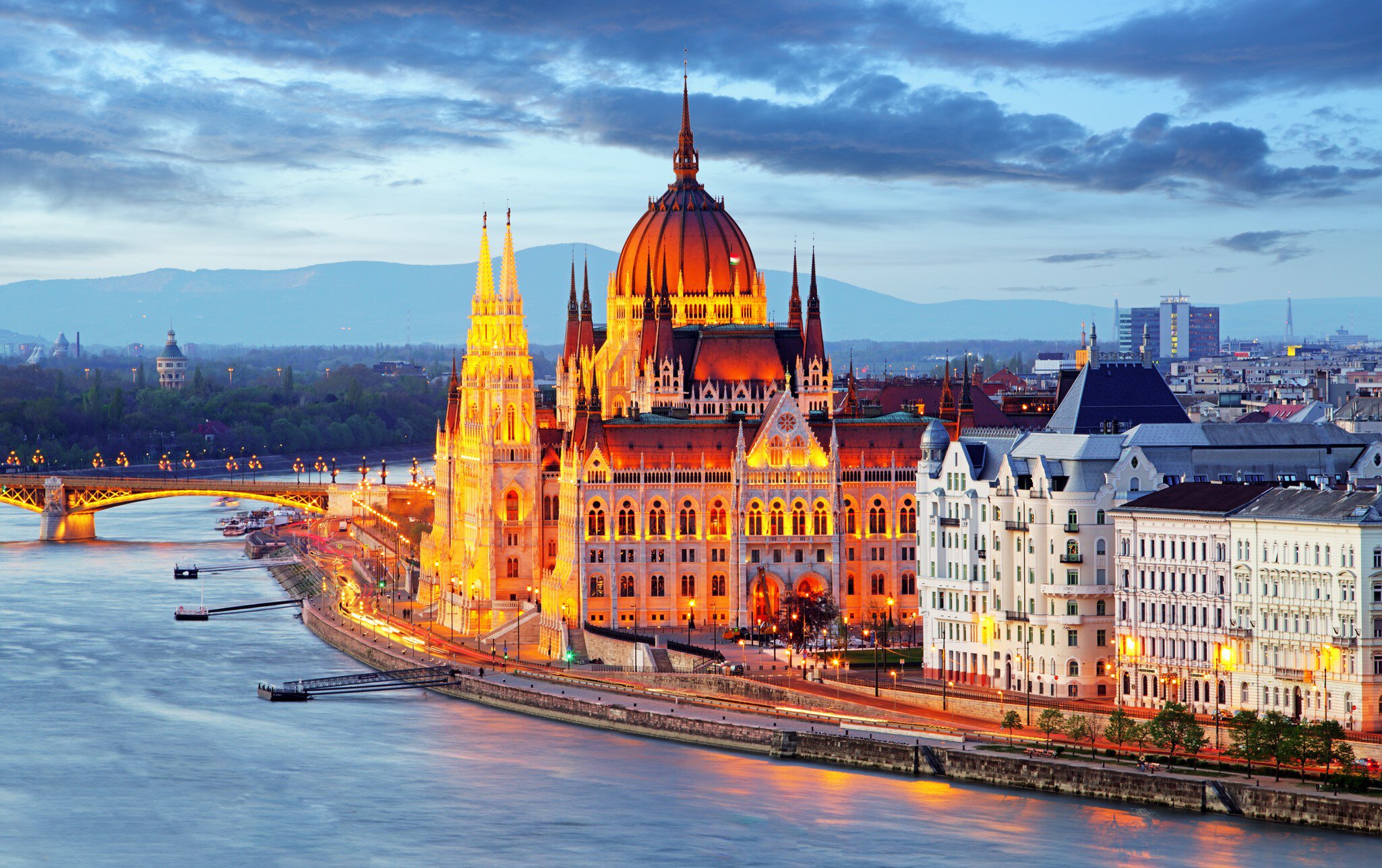 Hungarian Parliament Building illuminated at night.