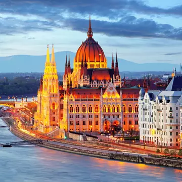 Hungarian Parliament Building illuminated at night.