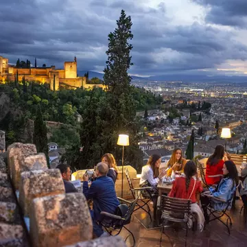 Experience sunset in Granada overlooking the illuminated Alhambra palace. Sergi Reboredo/VWPics/Universal Images Group/Getty Images