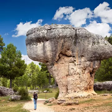 Landscape with man observing the karst rock formations of Ciudad Encantada (enchanted city) at the Serrania de Cuenca natural park, near the city of Cuenca in Spain.