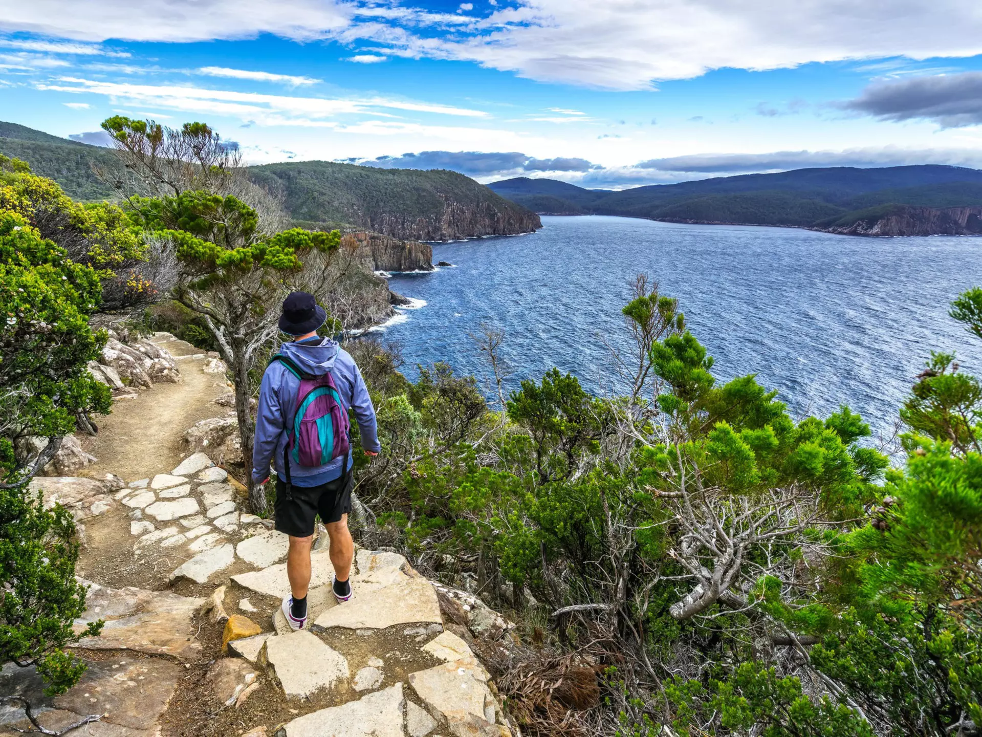 Man hiking toward Fortescue Bay along the coast.