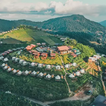 Aerial view of camping grounds and tents on Doi Mon Cham mountain in Mae Rim, Chiang Mai province, Thailand.