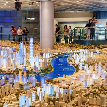 Shanghai, China - October 3, 2017: Tourists taking pictures of a large scale model of the city in the Shanghai Urban Planning Exhibition Center. The model showing all existing and approved buildings., License Type: media, Download Time: 2025-03-10T19:52:09.000Z, User: dermothegarty77, Editorial: true, purchase_order: 56530 - Guidebooks, job: Global Publishing WIP, client: China 17, other: Dermot Hegarty