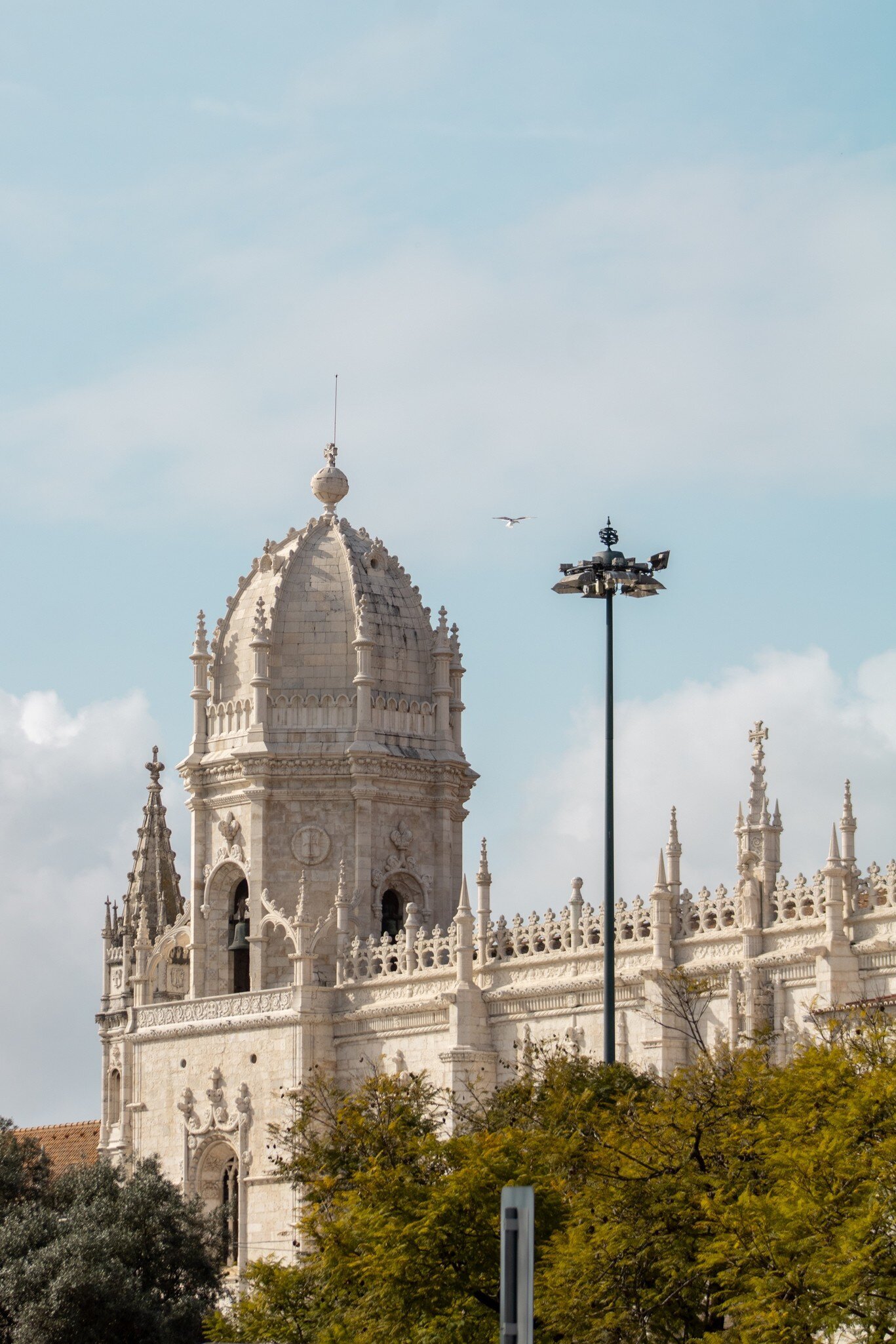 The exterior of the Mosteiro dos Jerónimos on a cloudy day in Lisbon, Portugal.