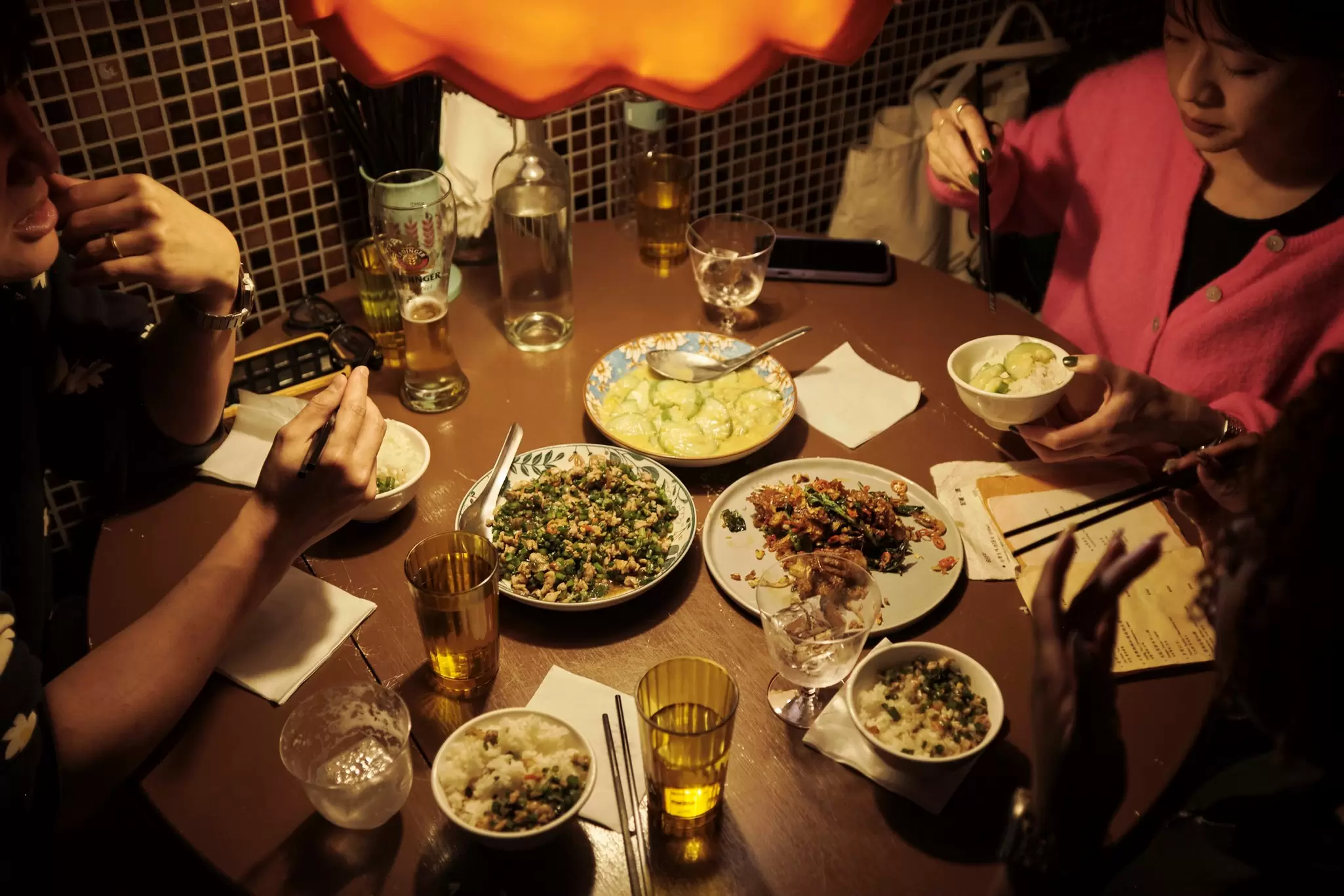 Table of Taiwanese dishes with diners around it in a thirdfloor bar and restaurant in TAIPEI CITY, TAIWAN
