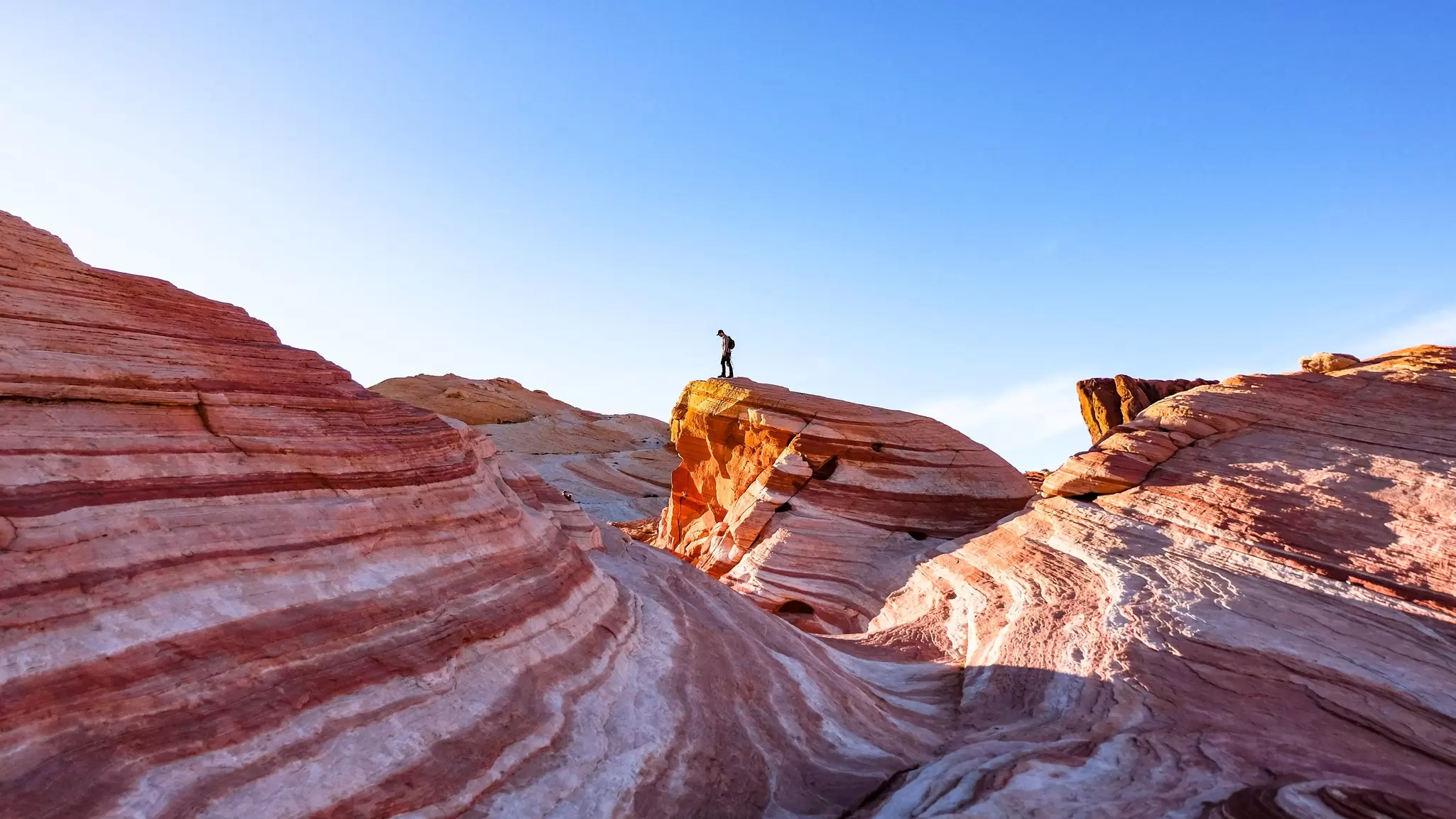 Hiking the Fire Wave in Valley of Fire State Park, Nevada. Ashley Hadzopoulos/Shutterstock