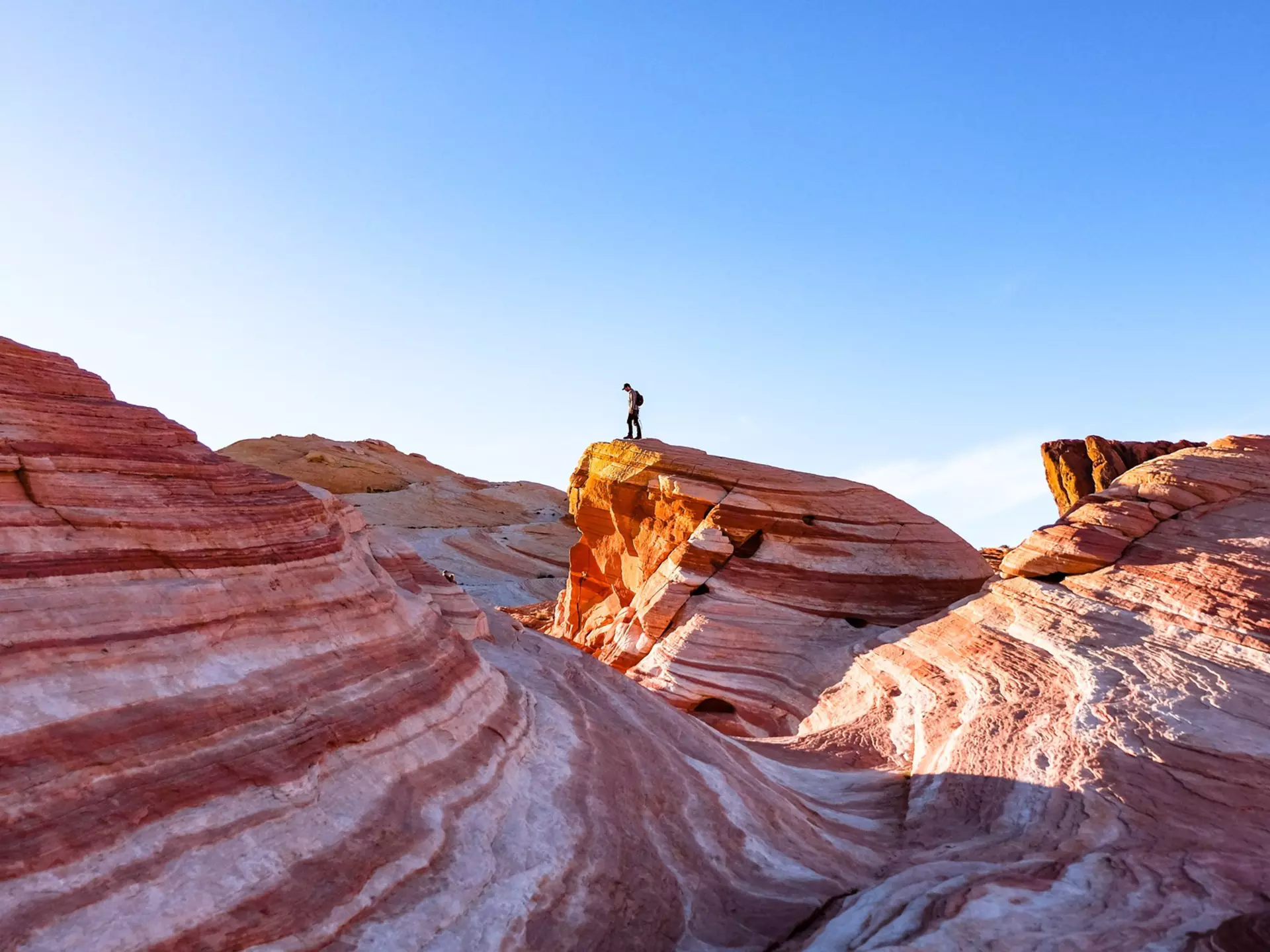Hiking the Fire Wave in Valley of Fire State Park, Nevada. Ashley Hadzopoulos/Shutterstock