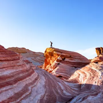 Hiking the Fire Wave in Valley of Fire State Park, Nevada. Ashley Hadzopoulos/Shutterstock
