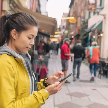 Woman using mobile phone app while walking in city street to find a store direction on map or order online at restaurant. Asian woman canadian city lifestyle.  License Type: media  Download Time: 2024-02-07T13:27:42.000Z  User: jennifercarey0150  Is Editorial: No  purchase_order: