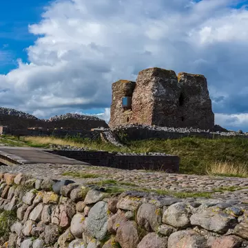 Rønde, Denmark: 08 14 2019: The remains of the historic danish fortress known as "Kalø Slotsruin" from the bridge leading to the old entrance with the big tower still standing tall.; Shutterstock ID 1657073812;