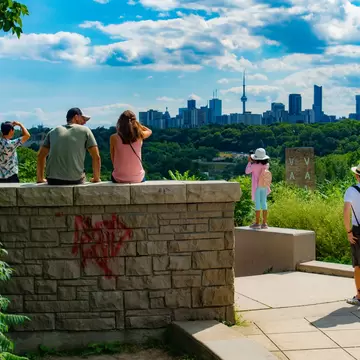 People enjoying Toronto City view in summer from Governors Monument, at Evergreen Brick Works. 