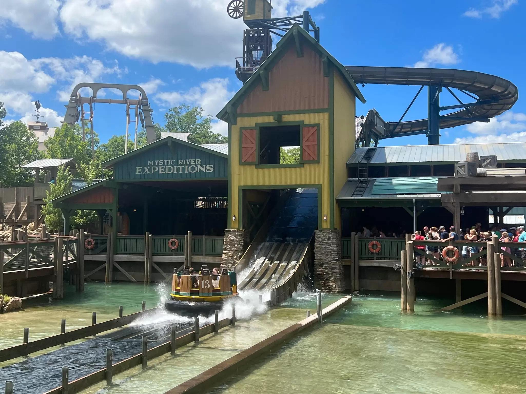 A water-based ride, with a large circular boat coming down rapids: Mystic River Falls at Silver Dollar City in Branson, Missouri. 