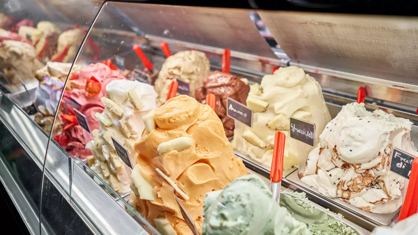 A counter of gelato in various colors and flavors in Rome, Italy.