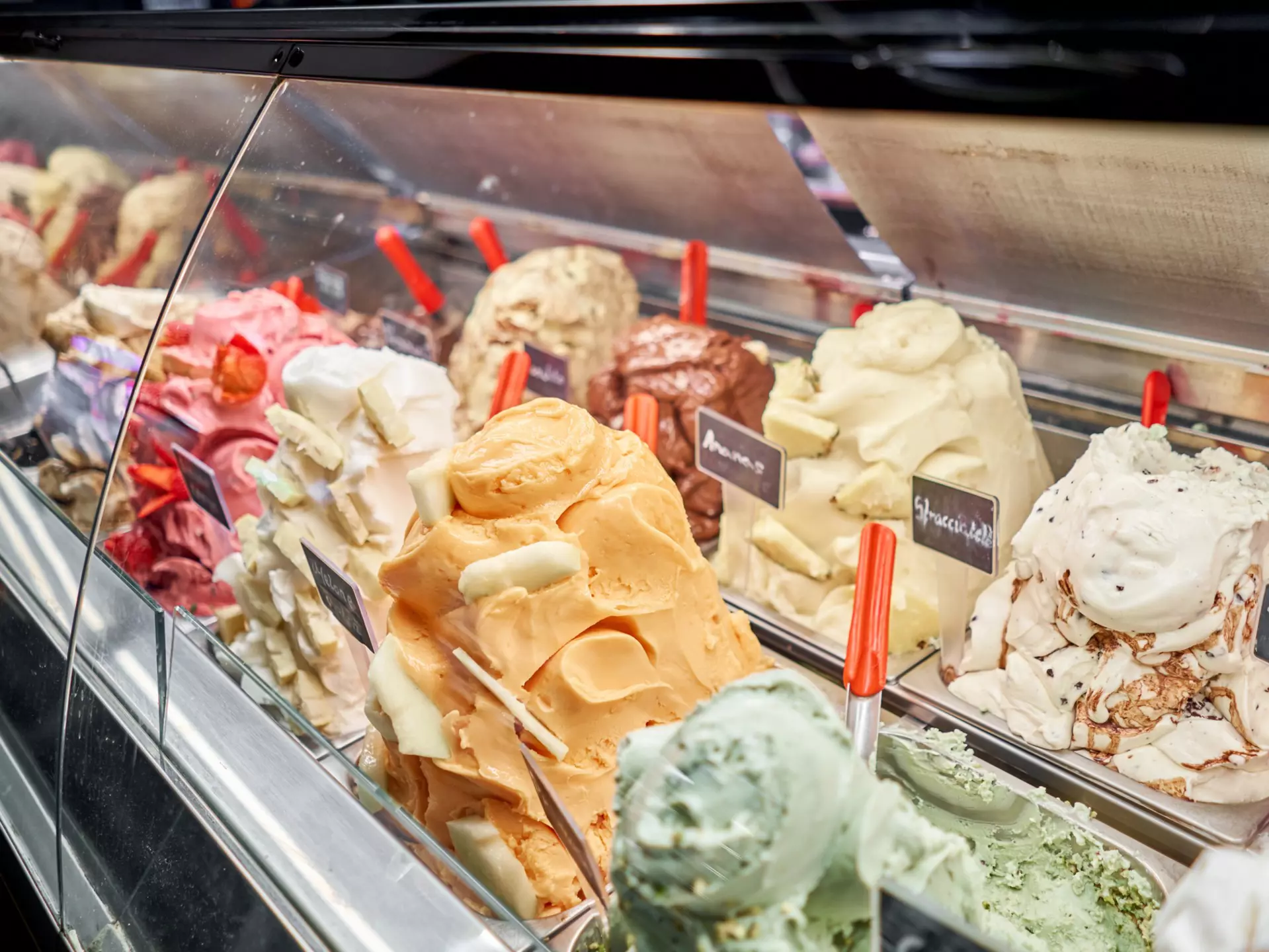 A counter of gelato in various colors and flavors in Rome, Italy.