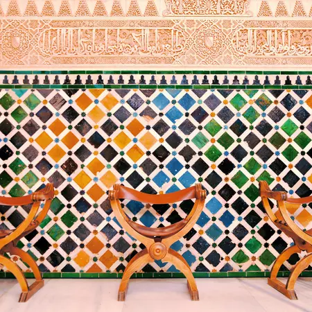 Colourful tiled wall in the courtyard of the Moorish styled palace of Alhambra.