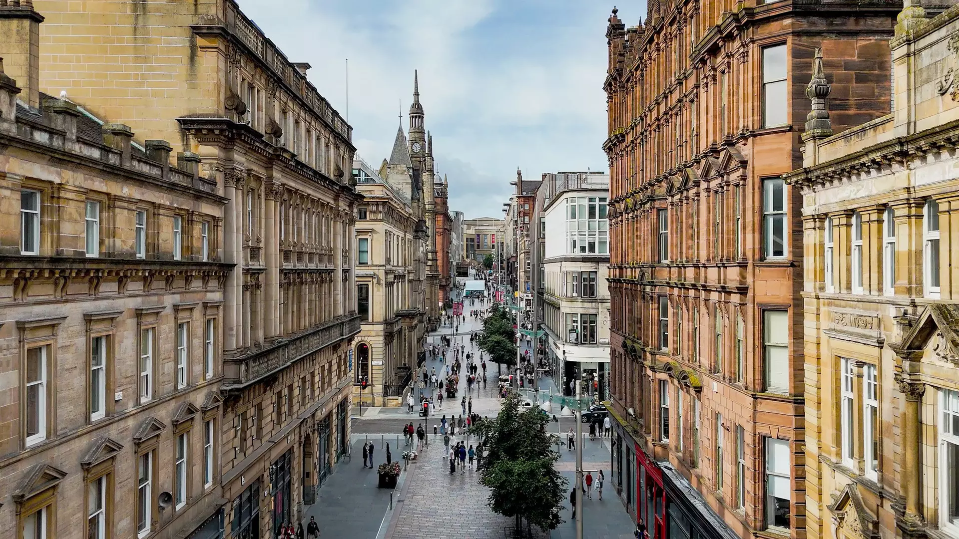 GettyImages-2248243116.jpgAerial view of Buchanan Street in Glasgow city center with historic sandstone buildings and pedestrian shopping zone, Busy urban street filled with people and retail stores, Tourism and lifestyle concept for travel design