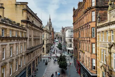 GettyImages-2248243116.jpgAerial view of Buchanan Street in Glasgow city center with historic sandstone buildings and pedestrian shopping zone, Busy urban street filled with people and retail stores, Tourism and lifestyle concept for travel design