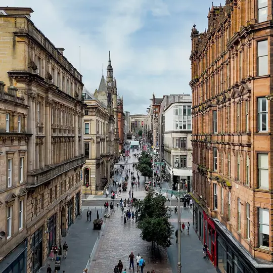 GettyImages-2248243116.jpgAerial view of Buchanan Street in Glasgow city center with historic sandstone buildings and pedestrian shopping zone, Busy urban street filled with people and retail stores, Tourism and lifestyle concept for travel design