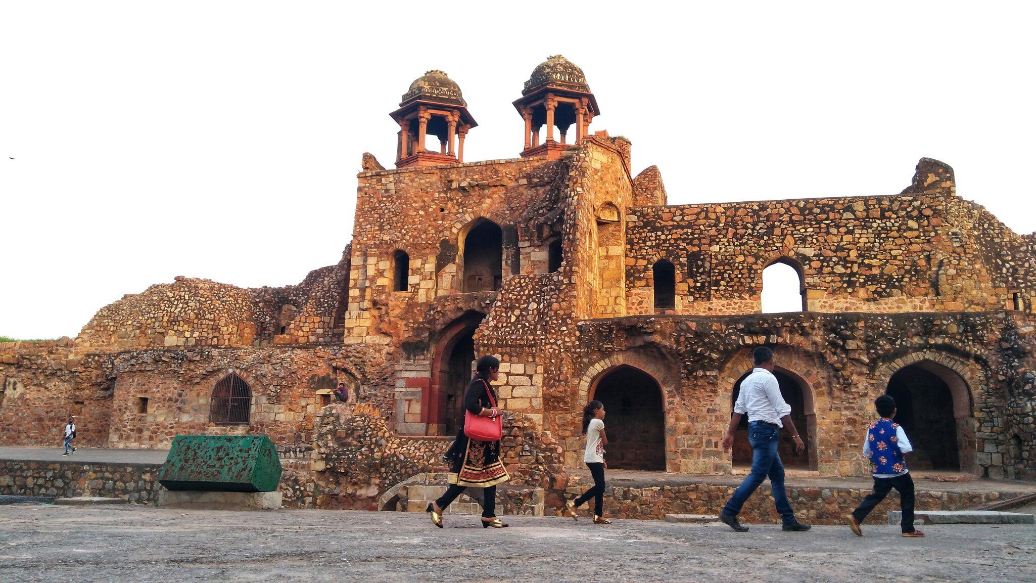Family explores the Purana Qila fort in New Delhi, India.