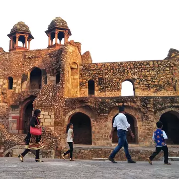 Family explores the Purana Qila fort in New Delhi, India.