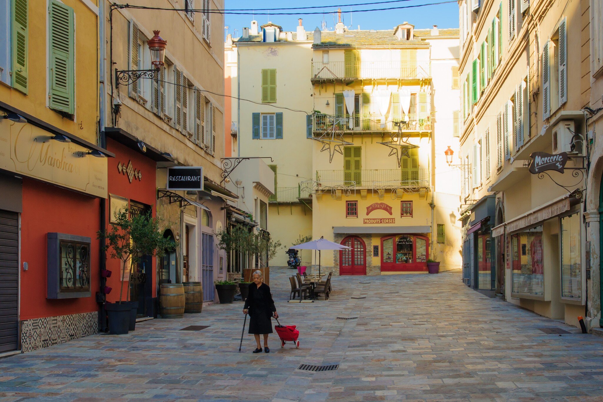 Woman walking in the terra vecchia (old quarter) area, in Bastia, Corsica, France. 