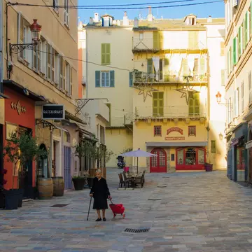 Woman walking in the terra vecchia (old quarter) area, in Bastia, Corsica, France. 