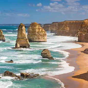 Limestone stacks standing in the surf below cliffs on the Victorian coast