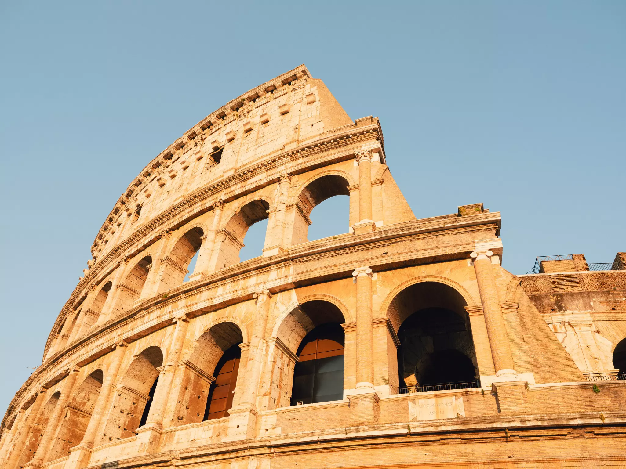 A view looking up at the columns of the Colosseum in Rome