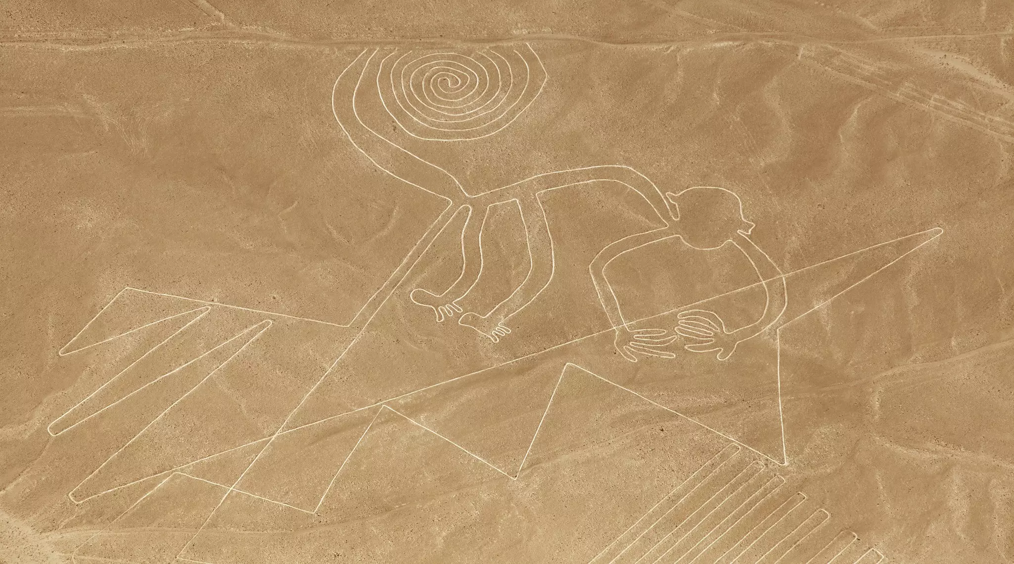 Monkey geoglyph, Nazca or Nasca mysterious lines and geoglyphs aerial view, landmark in Peru.